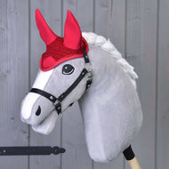 The Hobby Horse LarDen gray hobby horse features a white mane, black bridle, and Ear Bonnet Crocheted Red for fly protection, standing against a light wooden background.