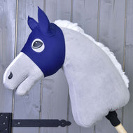 The Horse Mask LarDen by Hobby Horse LarDen is a gray plush hobby horse with a blue fabric bridle and white mane on a wooden stick—ideal for imaginative PES play, shown against a gray wooden wall.