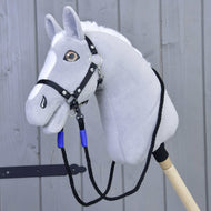 The Hobby Horse LarDen Reins Basic Blue is a gray plush hobby horse head with a black bridle and blue polypropylene rope reins on a wooden stick, shown against a light gray wooden wall background.