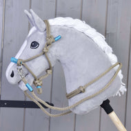 Tête grise en peluche de Hobby Horse LarDen avec crinière blanche et licol Ensemble de corde Nature Bleu, montée sur un bâton en bois, placée devant un fond de panneaux en bois gris.