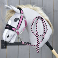The Hobby Horse LarDen Set LarDen Exclusive Pink features a grey plush hobby horse with a cream mane, pink and black bridle, matching fleece noseband and lead rope on a black stick, shown against a wooden background.