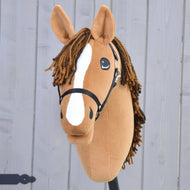 Hobby Horse LarDen’s handmade Hobby Horse Edward with Black Halter, inspired by a chestnut Hanoverian with a white blaze and yarn mane, is displayed in front of a gray wooden fence.
