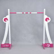 The Hobby Horse LarDen LarDen Hobby Horse Puissance Jump, in pink and white with horse head silhouettes and striped bar, stands against a plain gray background—ideal for Hobby Horse Puissance training.