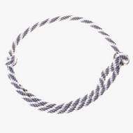 The Cordeo silver stripe by Hobby Horse LarDen features a handmade twisted black and white design, arranged in a circular shape with a simple knot on the right, displayed against a white background.