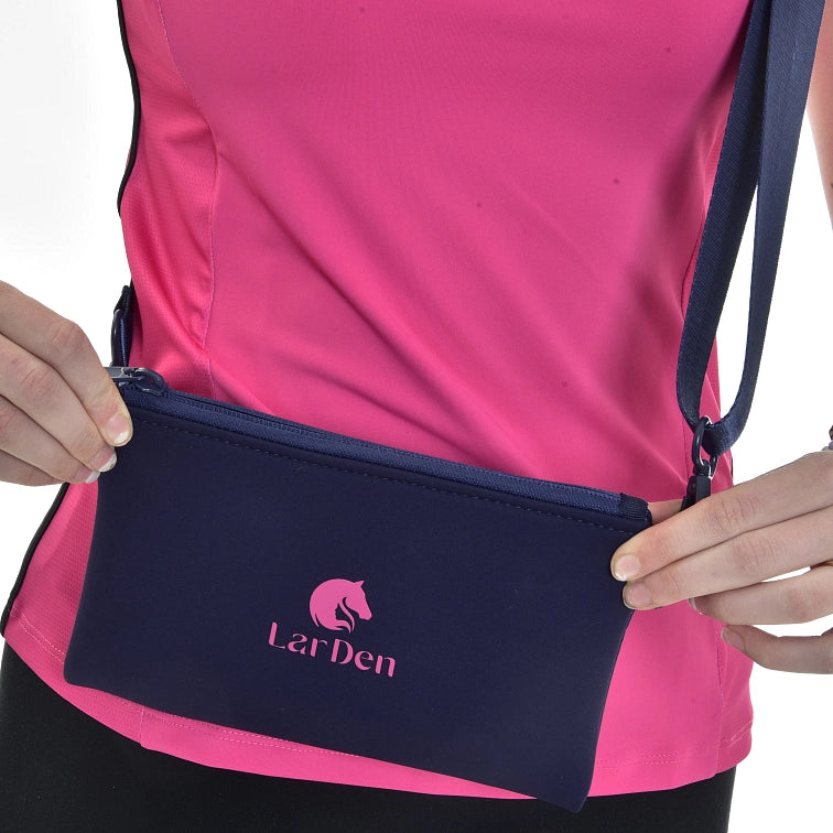 A person wearing a pink top holds a navy blue zippered pouch with a shoulder strap. The pouch, perfect for Hobby Horsing fans, features a pink horse logo and the word LarDen printed on it.