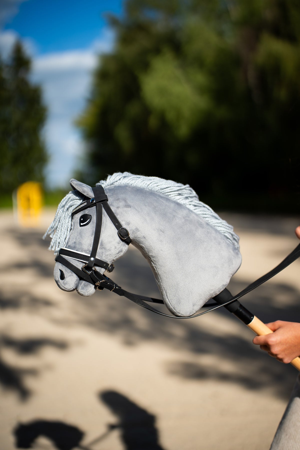 Hobby Horse Complete De Luxe bridle with 2 browbands on a gray Hobby Horse with white mane outdoors