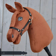 A “Build your horse” dark chestnut hobby horse head with a black bridle, from related_to_12441055625556, is mounted on a stick and displayed against a light wooden background.
