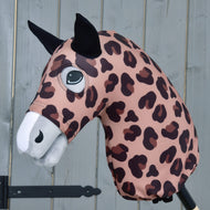 The Hobby Horse LarDen "Hobby Horse protective suit Glamour" features a pink and brown leopard print lycra pattern, black ears, and a white snout, shown on a stick against a gray wooden background.
