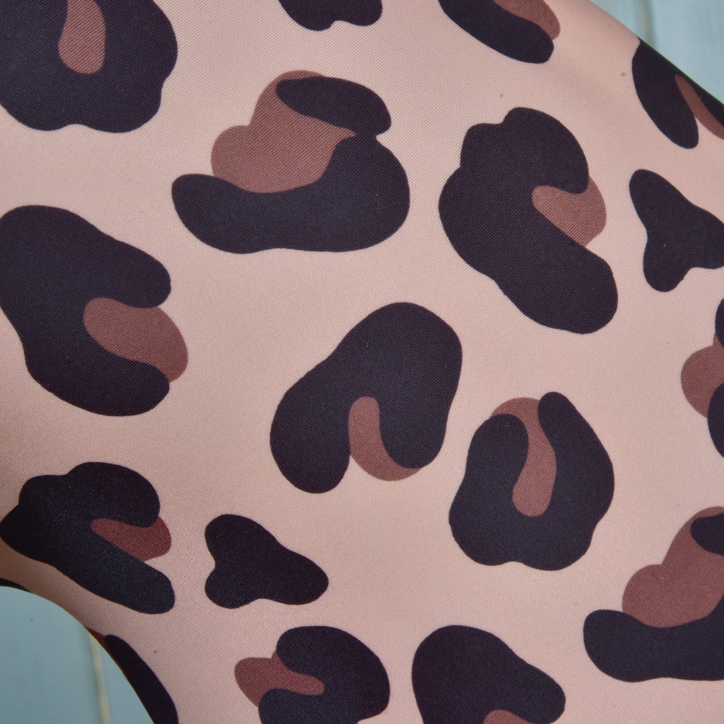 Close-up of the Hobby Horse LarDen Glamour protective suit, made from lycra fabric with a leopard print featuring irregular dark brown and black spots on a light beige background.